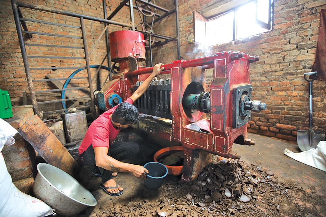 Close-up of oil being extracted from a traditional press.